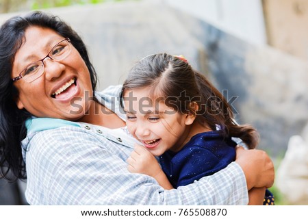Happy latin mom and little daughter outside. Royalty-Free Stock Photo #765508870