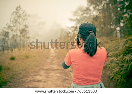 photographer woman take photo with mist view background