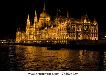 Majestic Budapest Parliament Building Illuminated at Night from the Historic Danube River.