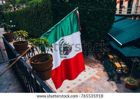 Mexican flag on a balcony at the center of Guanajuato