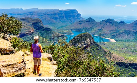 Senior woman enjoying the view of the Blyde River Canyon and Blyde River Dam from the highveld viewpoint along the Panorama Route in Mpumalanga Province of South Africa Royalty-Free Stock Photo #765547537