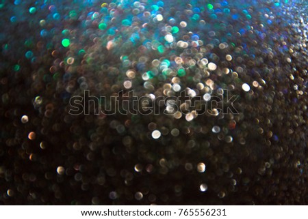 Abstract blurred bokeh of  dark siver twinkled glitter use for christmas background. New year holiday concept background.