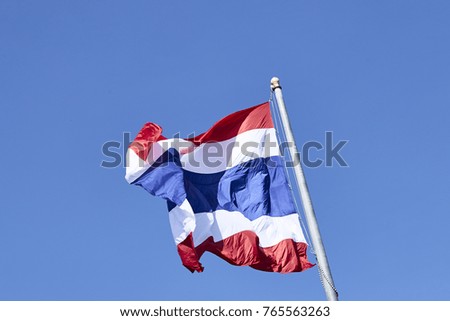 State national flag of Thailand waving on blue sky background.