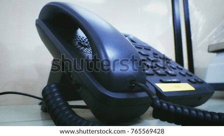 Closeup office black telephone on desk