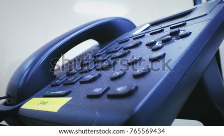 Closeup office black telephone on desk