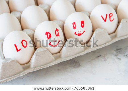 Enamored eggs in a box. Eggs with painted faces.