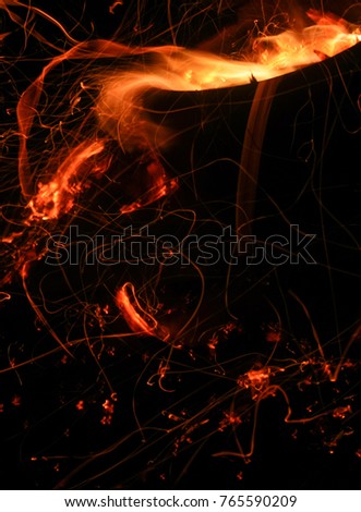 A bonfire spitting red-hot incandescent particles & flames. This photo was taken in Brisbane, Australia. 