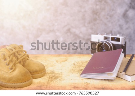 Travel concept, passport camera  notebook pencil and shoes on map.Traveler's accessories.