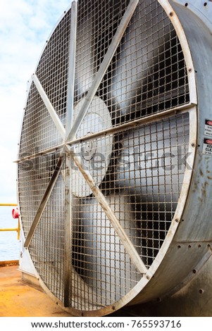 Big industrial cooler fan or huge cooling fan in factory for reduced and ventilation heat in the refinery process operation. Royalty-Free Stock Photo #765593716
