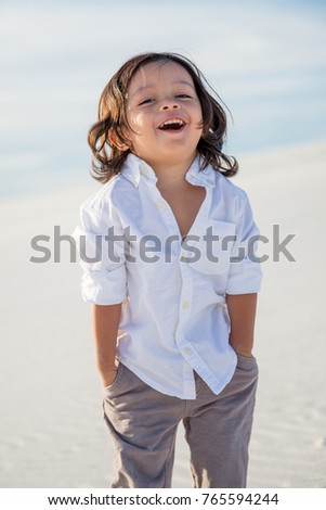 Toddler boy poses for a portrait at the White Sand Dunes, New Mexico, USA.