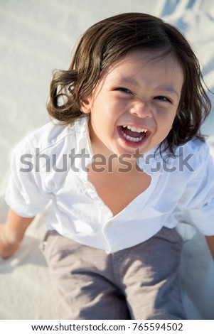 Toddler boy poses for a portrait at the White Sand Dunes, New Mexico, USA.
