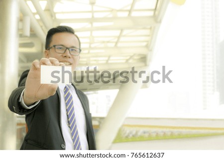 Businessman holding blank business name card 
