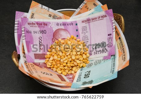 The brand new Indian currency bank notes of 200, 50 and 2000 rupees bundle. Success and got profit from business. GST tax on goods and service. Rise in price of food grocery, pulses affect poor people