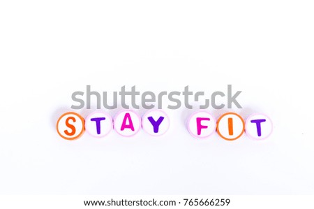 Words stay fit arranged by colorful rubber eraser with letter on white background