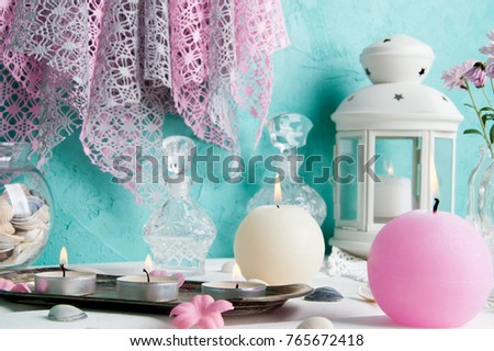 Pink and cream aroma candles, white candlestick and rose  chrysanthemums. Copy space for text.