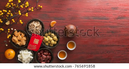 Flat lay Chinese new year food and drink still life on rustic wooden background. Translation of text appear in image: Prosperity. Royalty-Free Stock Photo #765691858