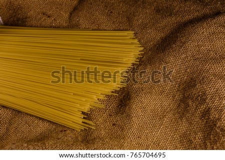 Bunch of spaghetti on rustic sackcloth. Top view