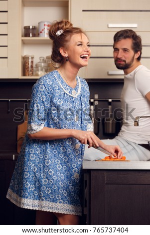 Photo of happy loving couple cutting vegetables in kitchen