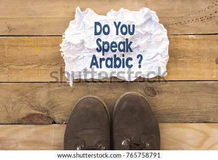 person stand up on wood and do you speak arabic ? written in crumpled and crashed paper
