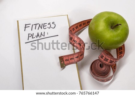 "Fitness Plan" black text on paper,  fitness, diet and healthy concept.  Workout and fitness,Planning control diet concept. sports, fitness, recording, notepad, concept of weight loss, diet, nutrition