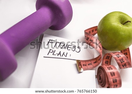 "Fitness Plan" black text on paper,  fitness, diet and healthy concept.  Workout and fitness,Planning control diet concept. sports, fitness, recording, notepad, concept of weight loss, diet, nutrition