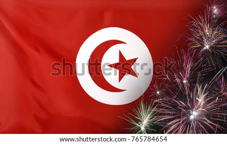 Textile flag of Tunisia with firework  close up with wind waves in the real fabric
