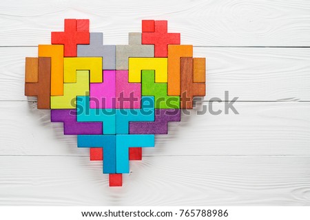 Heart made of colorful wooden shapes, top view, flat lay. Health background concept.