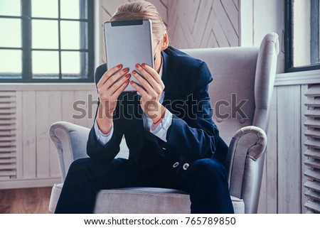 Stylish cooperative female using a tablet PC.