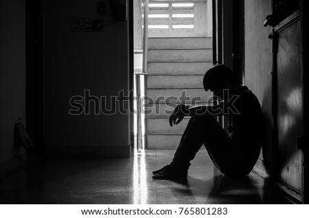 Silhouette of man sitting alone