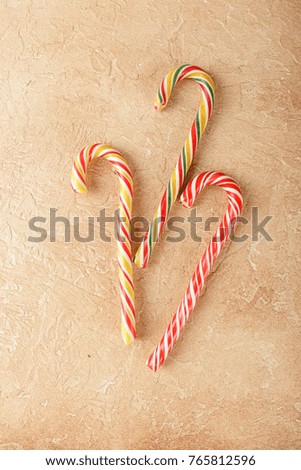 Sweet Candy canes on blue background. Flat lay. Top view.