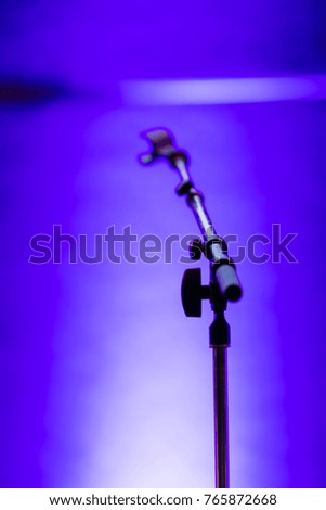 Empty Microphone Stand on a stage. Purple Blue lighting. Music recording. Music performance. 