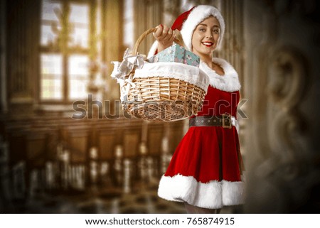 Santa claus woman in red dress and hat in dark retro interior of home.