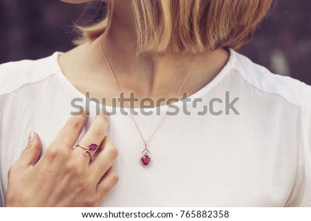 Woman wearing luxury necklace and ring  Royalty-Free Stock Photo #765882358