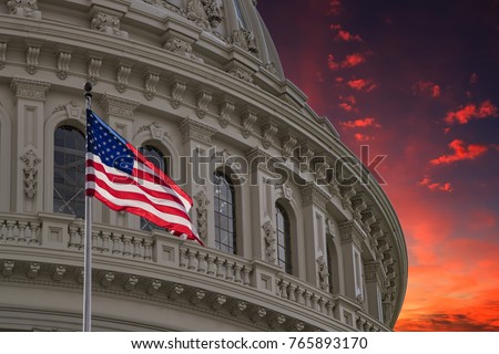 Washington DC Capitol dome detail with waving american flag Royalty-Free Stock Photo #765893170