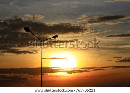Street light with orange sky during set set or sunrise