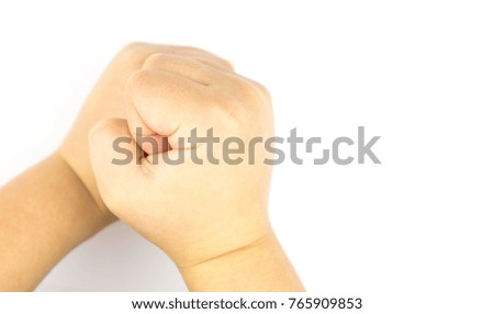 Hands of a child compressed into a fist on a white background.