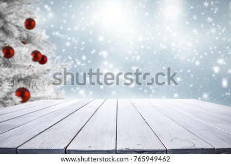 White desk with snow and christmas tree with red balls 