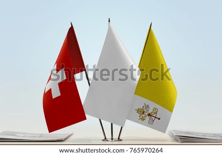 Flags of Switzerland and Vatican City with a white flag in the middle