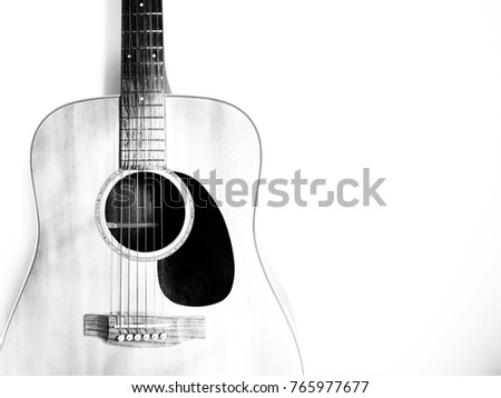 Guitar on a over exposed background with copy space. black and white picture color.Musical instruments have 6 lines. Play for entertainment.   Royalty-Free Stock Photo #765977677