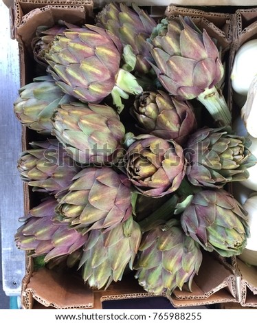 Close up picture of fresh artichokes at local farmers market 