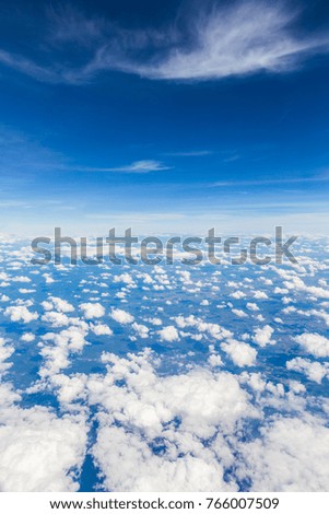 Aerial view of cloudy blue sky background.