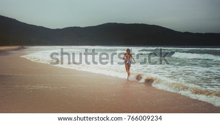 young woman doing fitness and health care concept at beach
