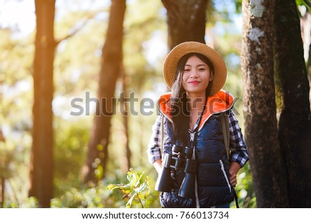 young girl backpack adventure outdoor ,Travel Photography journey nature park autumn sunset with copy space ,travel concept.