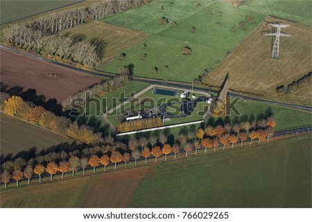 Aerial view of a road lined with trees in autumn near Saint Maxent in the department of the Somme In France
