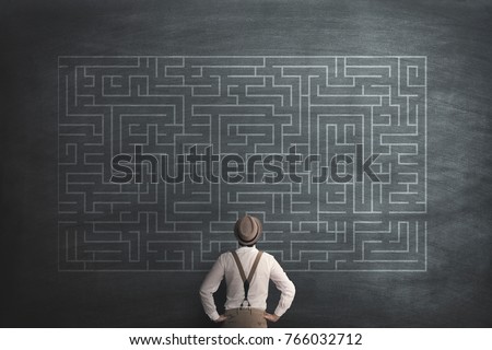 man try to solve a labyring on a chalkboard Royalty-Free Stock Photo #766032712