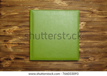 photo book with a hard cover on a wooden surface
green photo album with a leather cover
Photo album with a hard cover
background for photo publishing