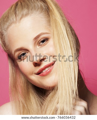 young pretty teenage woman emotional posing on pink background, fashion lifestyle people concept 