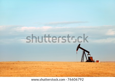 Working oil pump on Nebraska Great Plains Royalty-Free Stock Photo #76606792