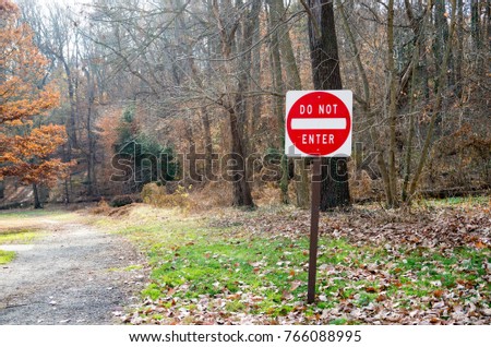 A bright red "Do Not Enter" sign at a trail entrance