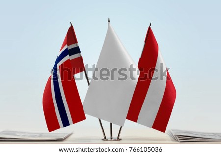 Flags of Norway and Austria with a white flag in the middle